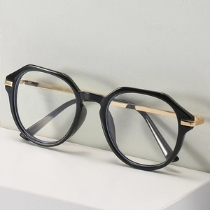 Chic polygonal black and gold glasses frame with metal temples shown from a side angle