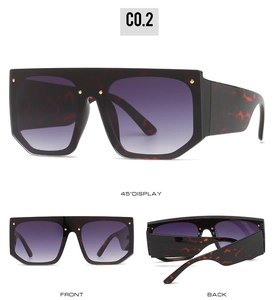 Detail view of oversized flat top sunglasses with tortoiseshell frame and gradient purple lens
