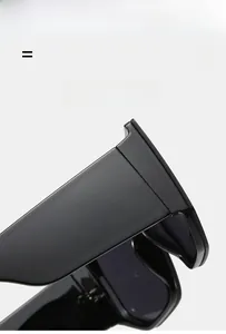 Detail of the high-gloss black acetate temple and hinge on oversized flat top sunglasses