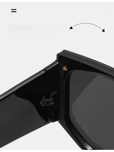 Detailed macro view of durable metal hinge on black flat top oversized sunglasses