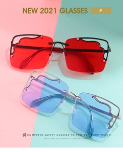 Close-up of frameless square sunglasses with wave-shaped hollow metal edges and blue lenses