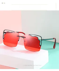 Detail of red square sunglasses featuring a unique black wavy metal inlay on the lens