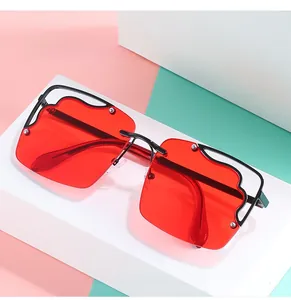 Detail of red oversized square rimless sunglasses with wavy edges and hollow frame