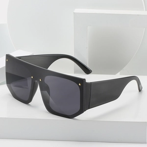 Flat top oversized one-piece sunglasses with black frame and gold rivet accents