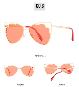 Three angles of oversized flower-shaped gold metal sunglasses with orange lenses
