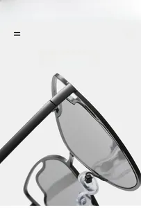 Detail of matte black metal sunglasses with grey lenses and flexible silicone nose pads
