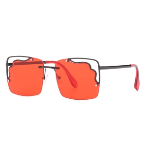 Modern oversized square sunglasses with red lenses and a black wavy top metal bar
