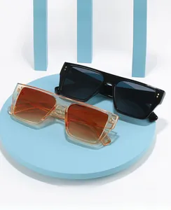 Flat top square sunglasses with decorative metal rivets on modern display stand