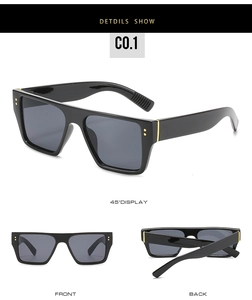 Detail view of black square sunglasses featuring gold rivet accents and metal trim details