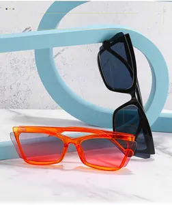 Detail of retro oversized cat-eye sunglasses in black and translucent orange PC frames