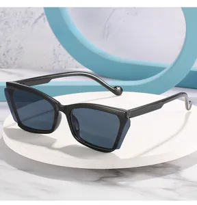 Macro view of cat eye sunglasses featuring multi-layered frame cutouts and ball-tip temples