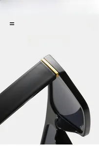 Detail view of durable golden metal hinges on lightweight black square sunglasses