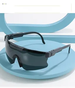 Detail of polarized sports sunglasses with adjustable temples on a minimalist blue stand