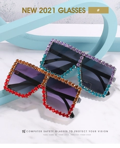 Detail of oversized square sunglasses with gradient rhinestone borders in warm and cool tones