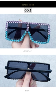 Close-up of oversized square sunglasses with purple and blue rhinestone gradient
