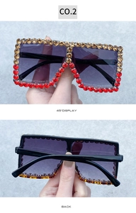 Detail of square rhinestone sunglasses in champagne gold and red color contrast