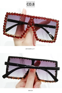 Macro detail of square rhinestone sunglasses with red crystals and tortoiseshell temples