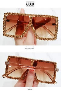 Detail view of large square sunglasses with champagne rhinestones and gradient lenses