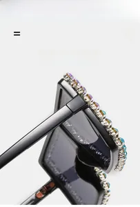Close-up of black oversized sunglasses featuring vibrant colorful rhinestone embellishments
