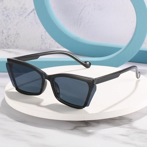 Modern black cat-eye sunglasses with dark grey lenses and unique geometric half-rim frame