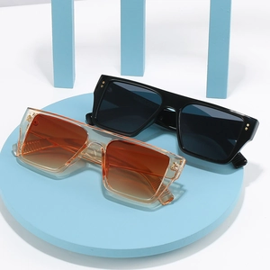 Flat top square sunglasses set with black and orange gradient lenses and gold rivets