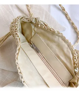 Detailed macro view of beige woven bag featuring high-quality silver zipper and smooth lining