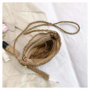 Macro shot of hand-woven straw bag interior featuring zipper pocket and multi-slots