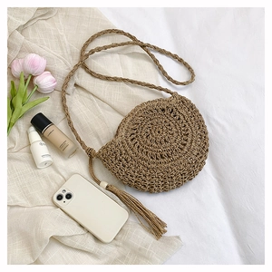 Macro shot of circular woven bag texture with wood bead tassel on white fabric