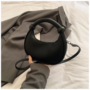 Minimalist black crescent handbag with vertical textures and chunky round handle for women