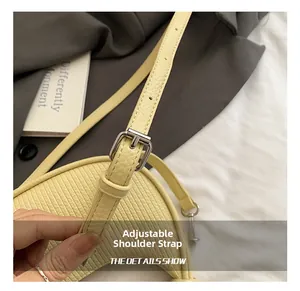 Detail of adjustable shoulder strap with silver buckle on cream lychee leather bag