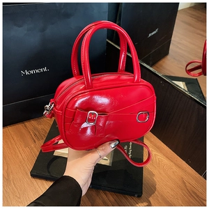 Fashionable red patent leather handbag with bow buckle and versatile shoulder strap