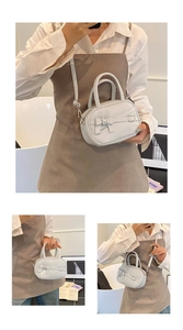 Detail of light gray mini crossbody bag with bow decoration and silver buckle detail