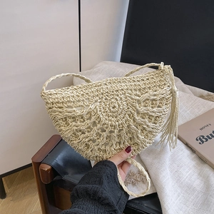 Beige woven straw half-moon crossbody bag with decorative tassels for women