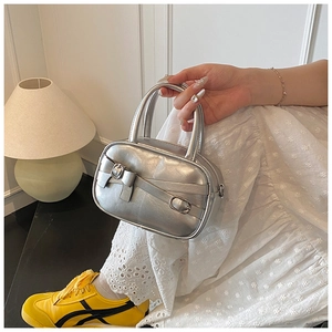 Mini silver metallic handbag featuring bow design and top handles for modern style