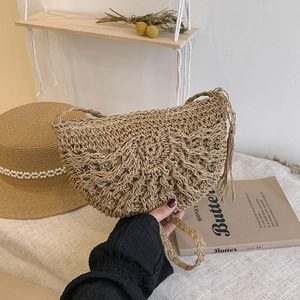Chic hollow straw shoulder bag with tassels for summer holidays in light khaki color