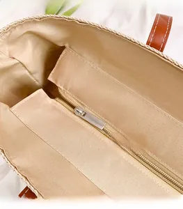 Detail of the interior lining with smooth silver zipper and durable brown leather handle straps