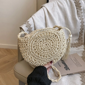 Handwoven beige round crossbody bag with tassel and braided strap for summer vacation