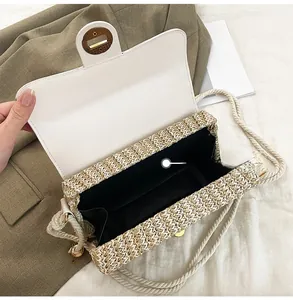 Detail shot of the internal compartment and texture of the woven straw crossbody bag