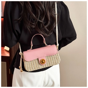 Detail of pink leather woven bag featuring golden twist lock and thick rope strap