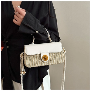 Detail of woven straw and white leather crossbody bag with golden twist lock and rope strap