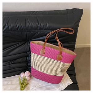 Detail of fuchsia and beige striped woven tote bag with brown synthetic leather straps