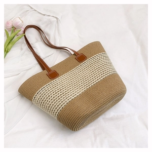 Close-up of the woven texture and faux leather handles on the striped straw tote bag