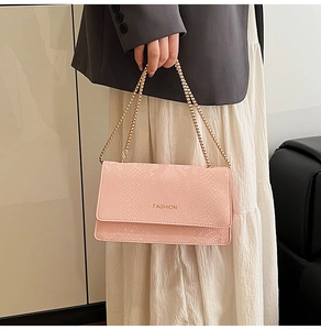 Pink snakeskin pattern handbag with gold chain strap and Fashion lettering on textured leather