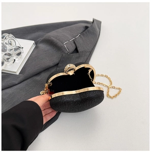 Détail de pochette de soirée noire à paillettes avec fermoir bague perle et chaîne