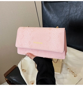 Pink snake skin crossbody bag with golden chain and yellow Fashion logo detail