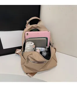 Spacious khaki water-resistant backpack showing organized interior with laptop and umbrella