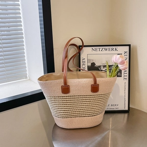 Beige large straw tote bag with brown leather handles for summer beach holidays