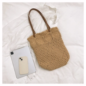 Top view of woven tote bag showing detailed crochet pattern and leather handles