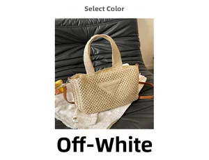Close-up of beige woven straw tote with signature triangle detail on black leather sofa