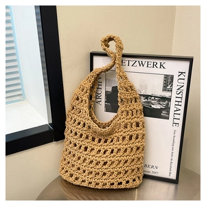 Detail of khaki woven tote bag showing handcrafted mesh texture and bohemian rope style